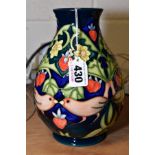 A MOORCROFT POTTERY BALUSTER VASE IN THE STRAWBERRY THIEF PATTERN, on a dark blue ground, circa
