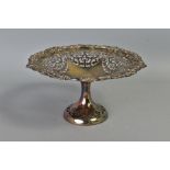 AN EDWARDIAN SILVER COMPORT, foliate cast rim surrounding foliate scroll pierced bowl, on a plain