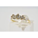 A YELLOW METAL THREE STONE DIAMOND RING, designed with three claw set, graduated round brilliant cut