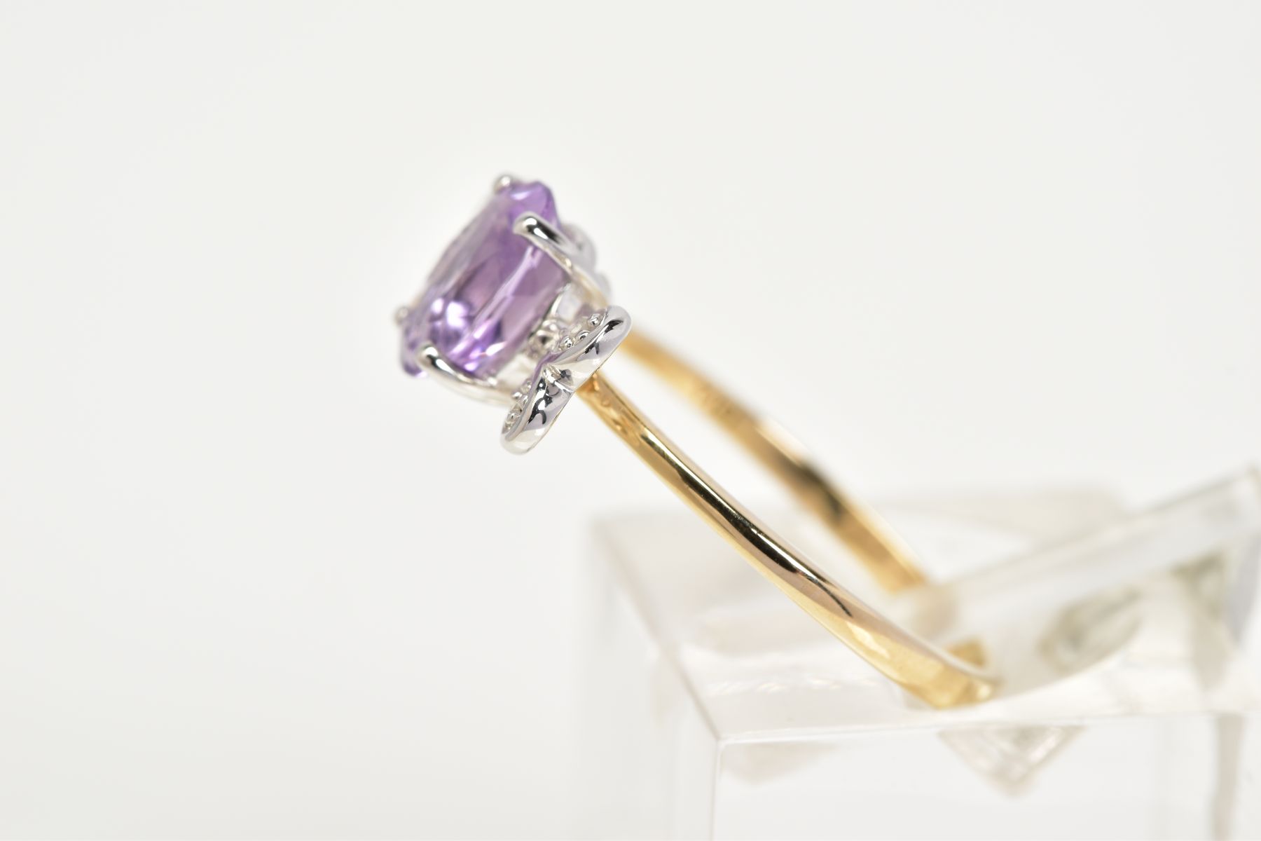 A 9CT GOLD AMETHYST AND DIAMOND RING, set with a central oval cut amethyst flanked with single cut - Image 2 of 3