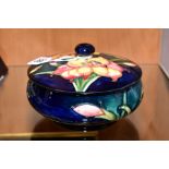 A MOORCROFT POTTERY POWDER BOWL AND COVER, 'Freesia' pattern on blue ground, impressed backstamp