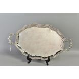 A MODERN MALTESE STERLING SILVER OVAL TWIN HANDLED TRAY, of wavy oval form, cast foliate scroll