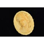 A VICTORIAN HIGH RELIEF IVORY BROOCH, of oval shape, carved depicting a gentleman in profile with