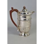 A GEORGE V SILVER HOT WATER JUG, domed cover, stop fluted body, stepped circular foot, makers Walker