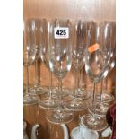 A SET OF TWELVE CLEAR GLASS CHAMPAGNE FLUTES, slender stem, circular plain foot, height 23cm (12)