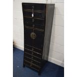 A TALL ORIENTAL EBONISED CONCAVE CHEST OF NINE DRAWERS with central double cupboard doors, width