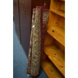 TWO MODERN RED GROUND RUGS, largest size 177cm x 118cm, together with a mahogany piano stool (3)