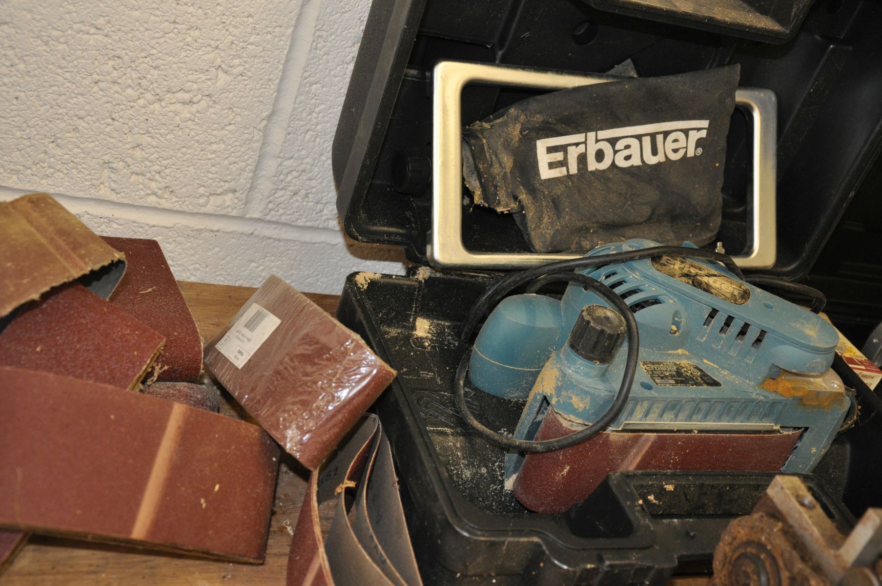 A CASED ERBAUER 3'' ELECTRIC BELT SANDER, with spare belts