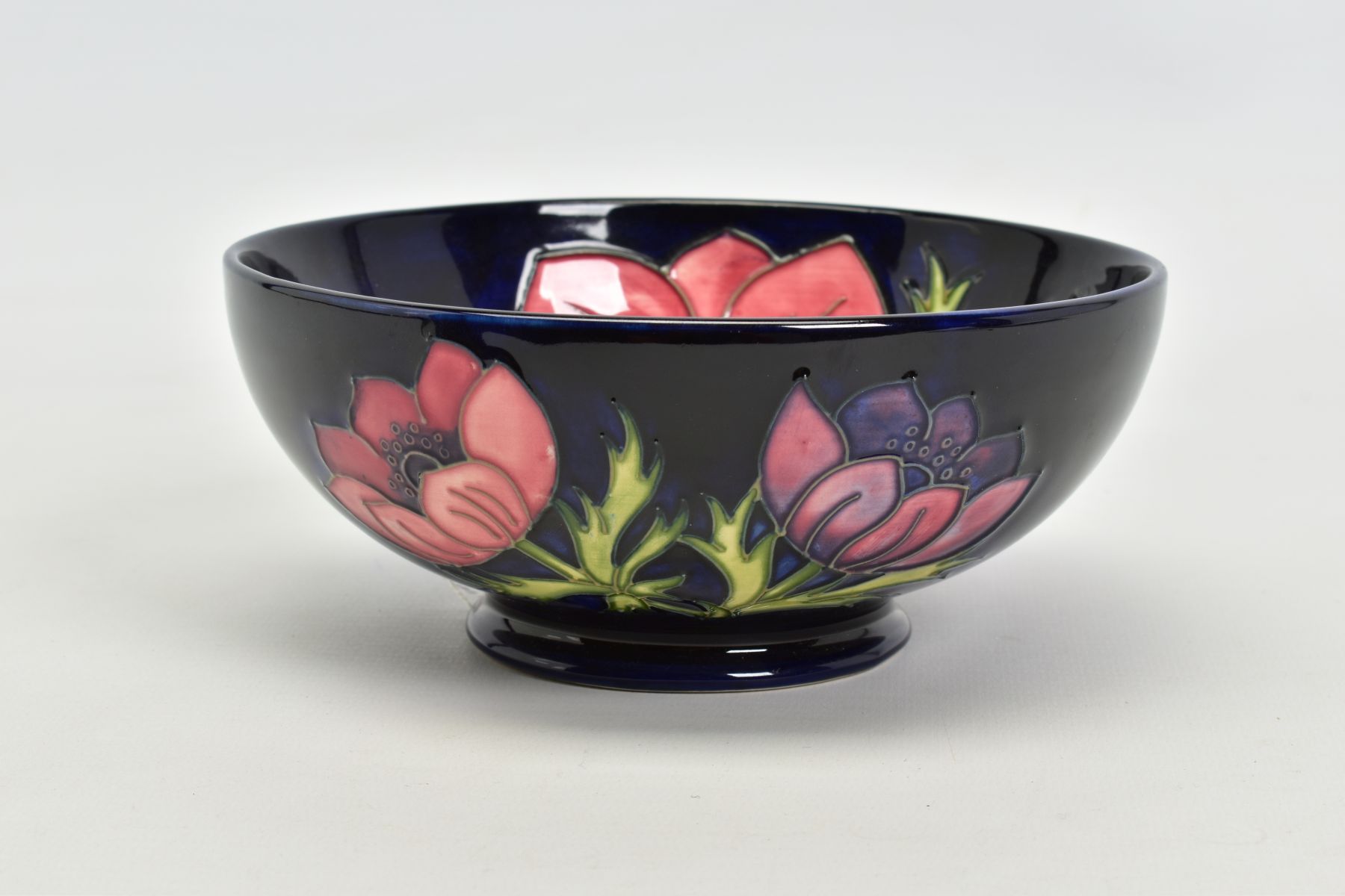 A MOORCROFT POTTERY FOOTED BOWL, 'Anemone' pattern on dark blue ground, impressed backstamp, No 34/ - Image 2 of 3