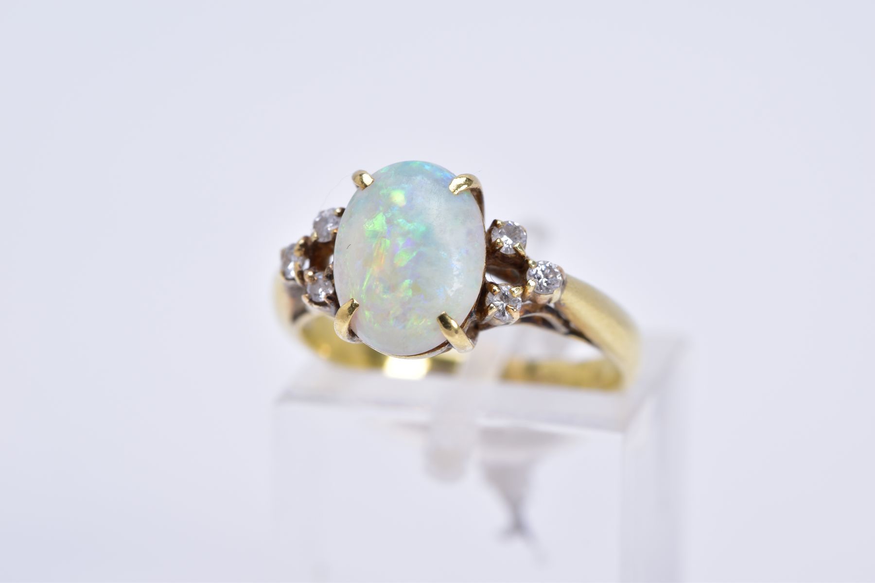 A MODERN OPAL AND DIAMOND DRESS RING, opal measuring approximately 10mm x 7.5mm (condition: small