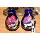 TWO SMALL MOORCROFT POTTERY VASES, 'Anemone' pattern on blue ground, backstamps to both (one