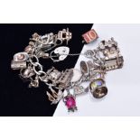 A SILVER CHARM BRACELET, suspending twenty-four charms such as a hinge open church, opens to