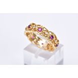 AN 18CT GOLD RUBY AND DIAMOND WIDE BAND RING, of openwork design set with alternating circular cut