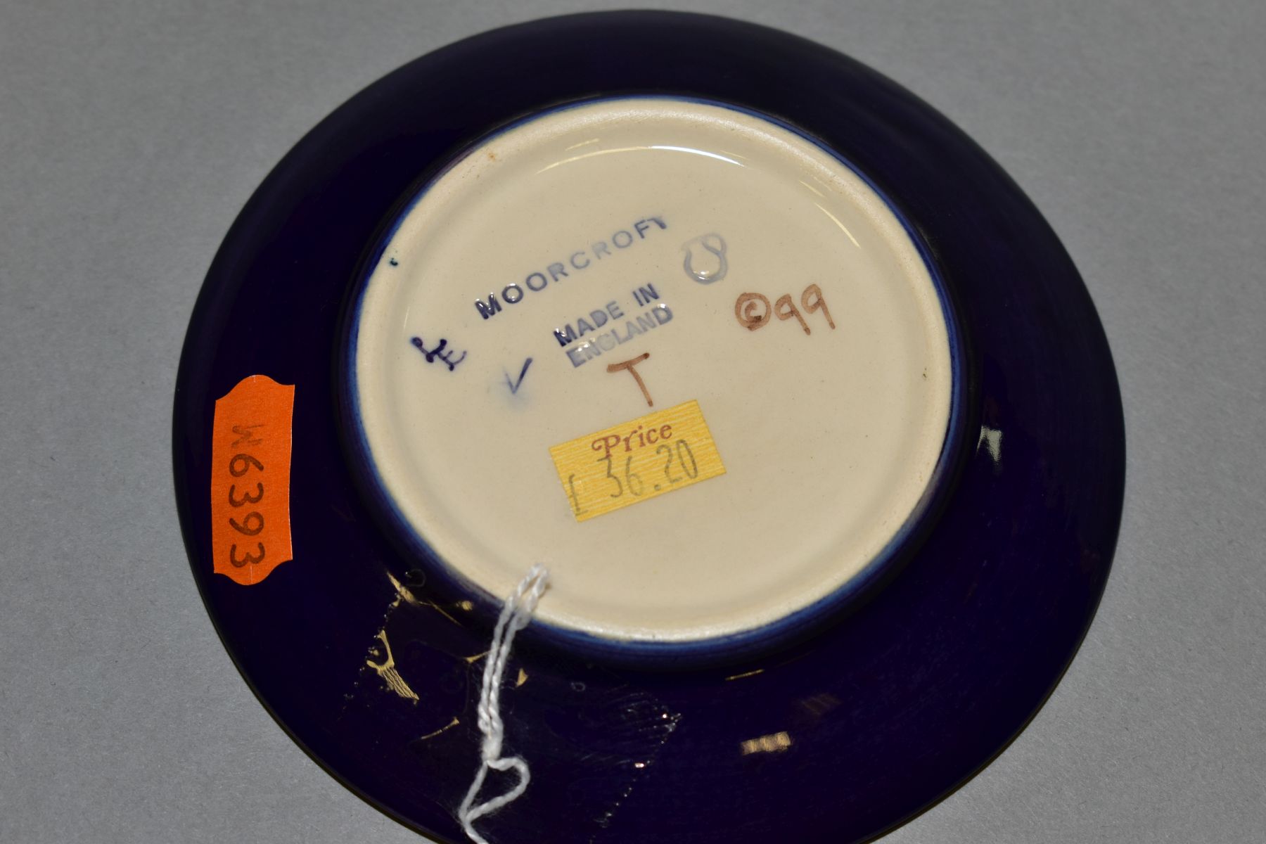 A MOORCROFT CIRCULAR COASTER DECORATED IN THE PLUMS AND BLOSSOM PATTERN, marked with 'T' as a - Image 2 of 2