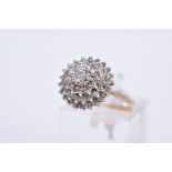 A 9CT GOLD DIAMOND CLUSTER RING, the tiered cluster with a central round brilliant cut diamond and