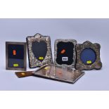 FIVE SILVER MOUNTED PHOTOGRAPH FRAMES, comprising a George V rectangular plain frame, easel loose,