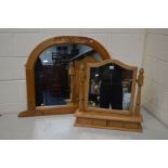 A MODERN PINE WALL MIRROR with foliate detail to top and bottom corners together with a pine swing