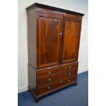 A GEORGIAN MAHOGANY AND CROSSBANDED TWO DOOR LINEN PRESS, the flame mahogany panelled doors