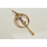 A YELLOW METAL OPEN WORK PENDANT, of circular design set with a central oval cut amethyst with