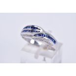 A MODERN SAPPHIRE AND DIAMOND DRESS RING, calibre cut sapphires channel set of modern round