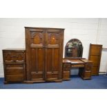 AN EARLY TO MID TWENTIETH CENTURY OAK FOUR PIECE BEDROOM SUITE, with carved decoration including