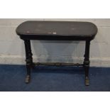 A LATE VICTORIAN EBONISED FOLD OVER CARD TABLE, on fluted legs united by a turned stretcher, width