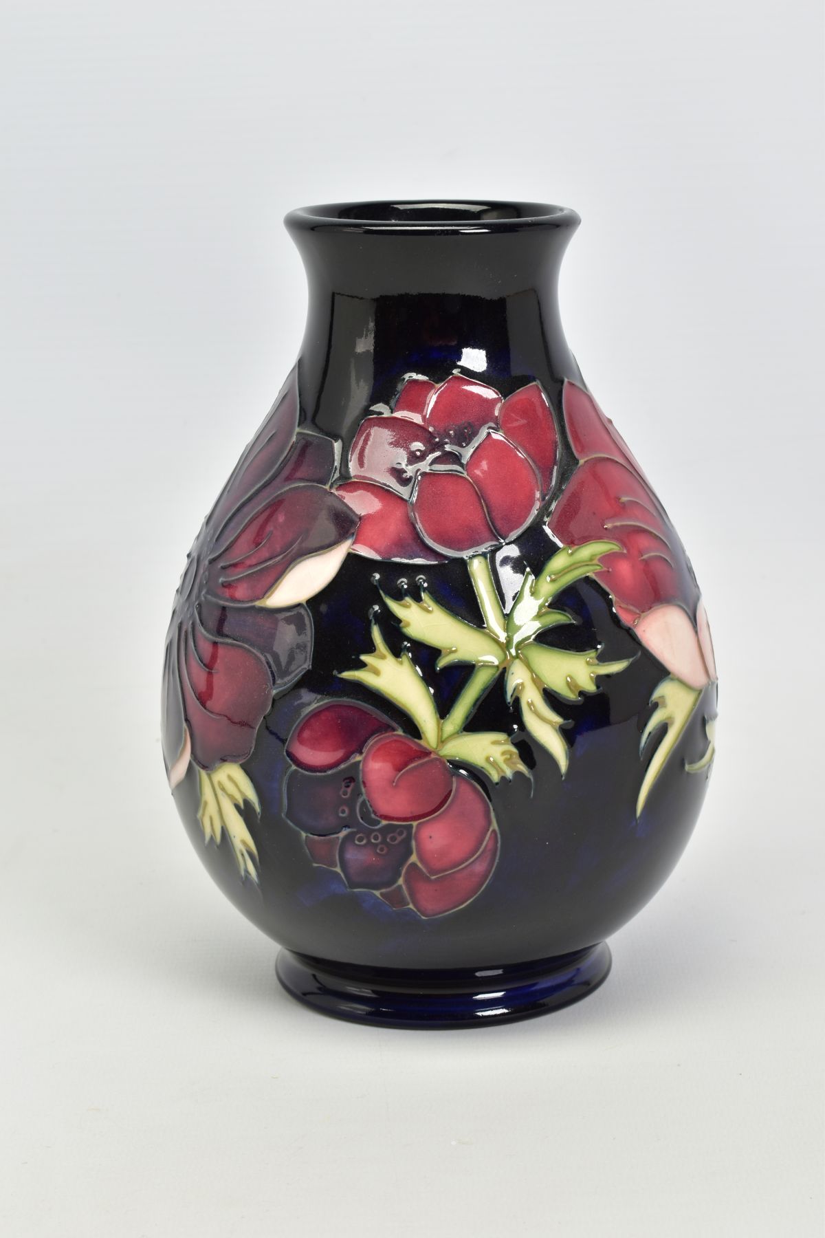 A MOORCROFT POTTERY VASE, 'Anemone' pattern on dark blue ground, impressed backstamp, No 34/94