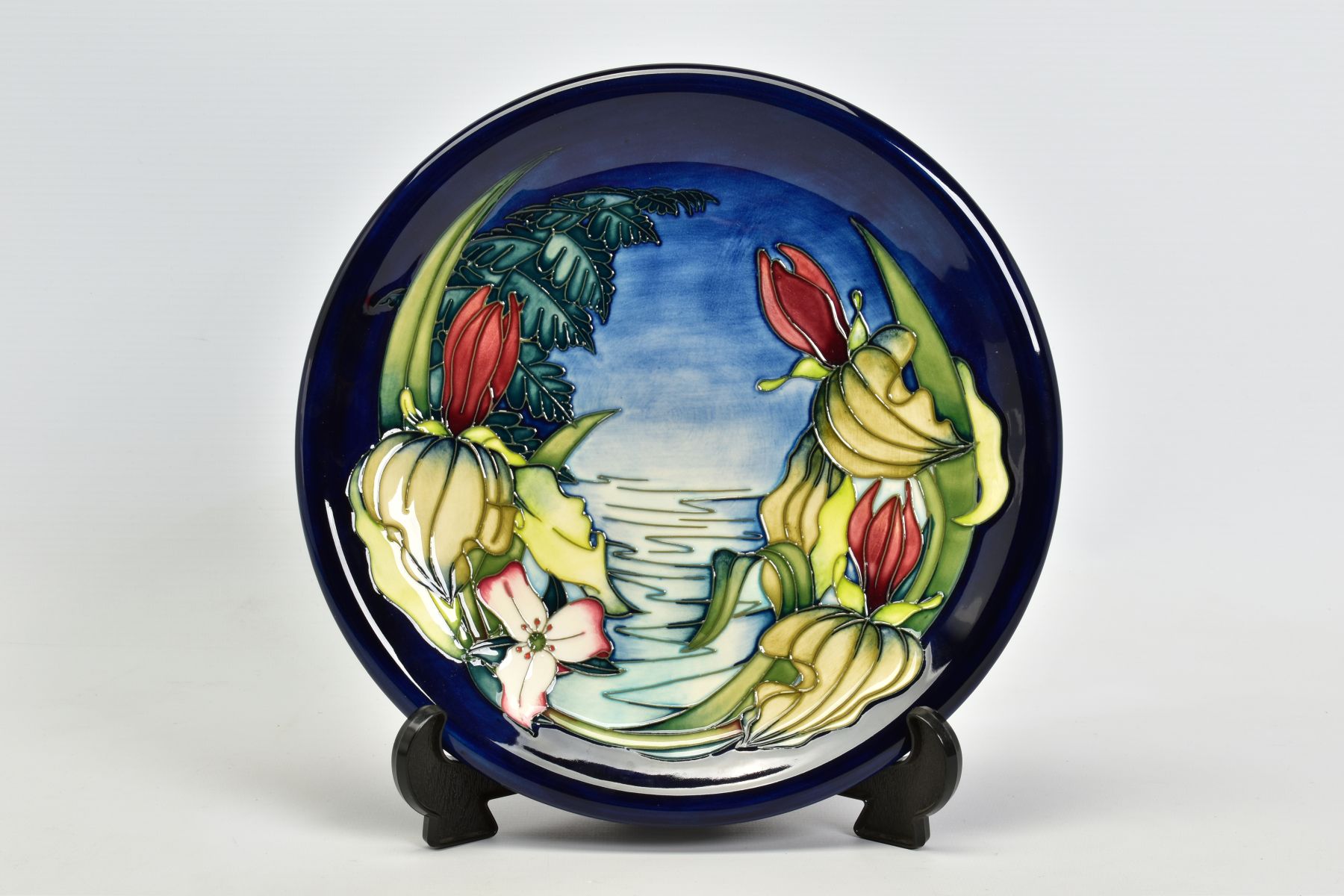 A BOXED MOORCROFT POTTERY PLATE, 'Sweet Betsy' pattern on blue ground, impressed backstamp, - Image 2 of 3
