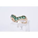 A 9CT GOLD EMERALD RING, of 'v' shape design set with square cut emeralds, plain polished band,