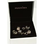 A COLLECTION OF SIX PANDORA CHARMS, to include a dice, letter C initial set with colourless paste,