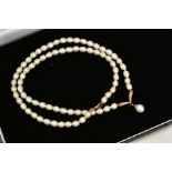 A CULTURED PEARL NECKLACE, designed with a V shape yellow metal section stamped 9k, suspending a