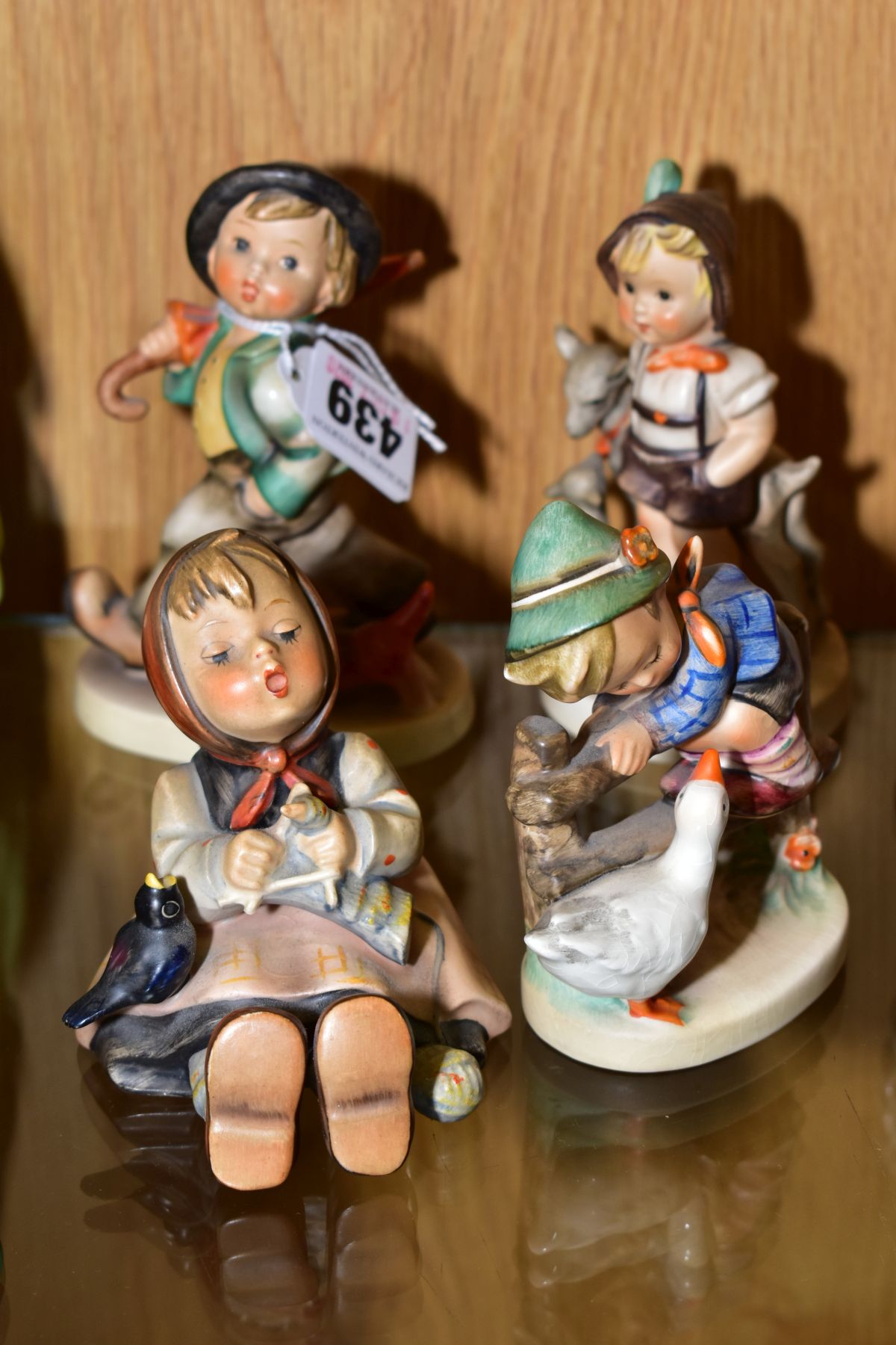 FOUR HUMMEL FIGURES 'Strolling Along HUM5, 'Happy Pastime' HUM69, 'Barnyard Hero' HUM195 and 'Little