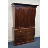 A GEORGIAN MAHOGANY DOUBLE DOOR LINEN PRESS, with an overhanging cornice, the doors with later