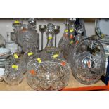 A GROUP OF MOSTLY CUT GLASS ITEMS, to including five decanters, a ships decanter a candle holder