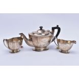 A GEORGE vi SILVER THREE TEA SERVICE OF SHAPED RECTANGULAR FORM, comprising tea pots, milk jug and