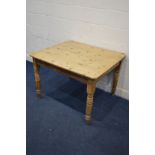 A VICTORIAN PINE PLANK TOP KITCHEN TABLE on turned legs, width 105cm x depth 93cm x height 73cm