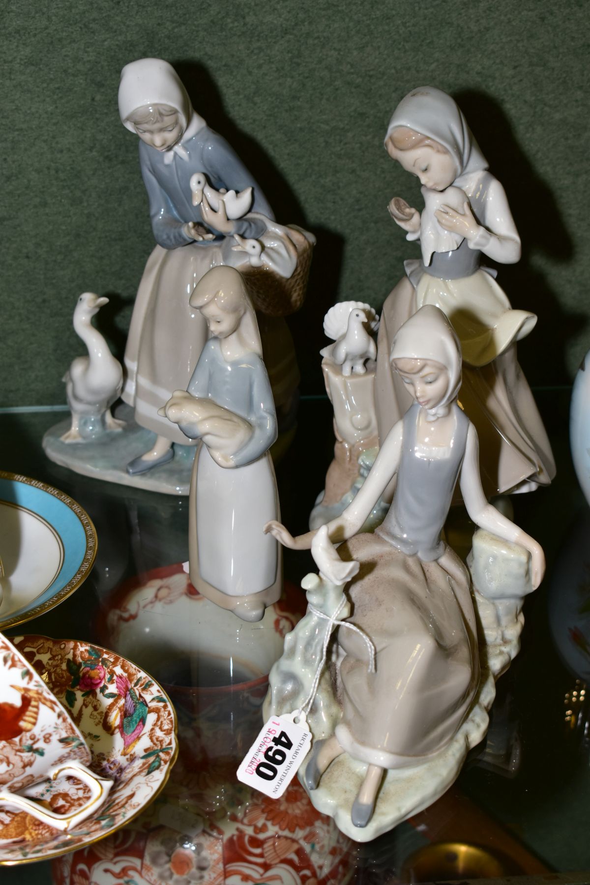 FOUR LLADRO FIGURINES, comprising girl reclining on ground with dove seated on a branch, a young