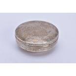 A SILVER EMBOSSED LIDDED BOX, of circular design, floral and scroll detailing to the lid, Pre