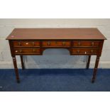 AN EDWARDIAN DRESSING TABLE/DESK with five drawers on turned legs, width 135cm x depth 48cm x height