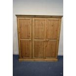 A MODERN PINE TRIPLE DOOR WARDROBE, width 184cm x depth 59cm x height 198cm