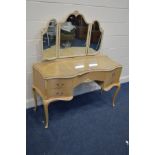 A CREAM AND GILT DRESSING TABLE with triple mirrors and five drawers, width 123cm x depth 56cm x