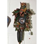 A MID TWENTIETH CENTURY CUCKOO CLOCK with pendulum and weights, made in Germany height approximately