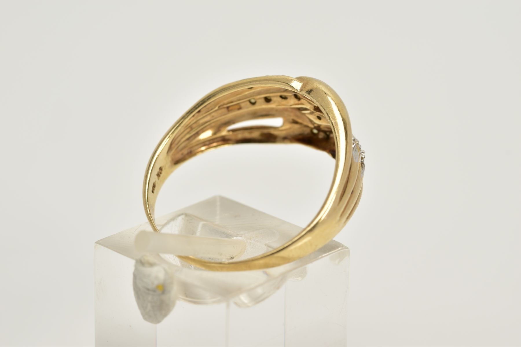 A 9CT GOLD DIAMOND OPENWORK RING, designed with four interlocking openwork hoops, two hoops set with - Image 3 of 3