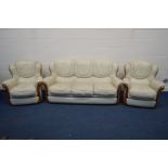 A CREAM LEATHERETTE THREE PIECE SUITE, comprising of a three seat settee and two arm chairs (3)