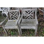 A PAIR OF HARDWOOD GARDEN CHAIRS (seat width 48cm between arms) and four folding pine garden