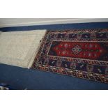 A 20TH CENTURY WOOLEN KUBA STYLE RED AND BLUE GROUND CARPET SQUARE, 149cm x 230cm, together with a