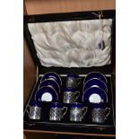 A CASED SET OF SIX EARLY 20TH CENTURY AYNSLEY COFFEE CANS IN SILVER SLEEVES AND SAUCERS, blue and