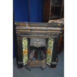 AN EARLY 20TH CENTURY CAST IRON FIRE INSERT, flanked with floral tile inserts, width 105cm x depth