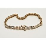 A 9CT GOLD DIAMOND TENNIS BRACELET, designed with thirty-eight barrel shape links each set with a