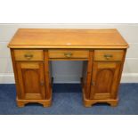 A VICTORIAN SATINWOOD KNEE HOLE DESK, with three drawers over two pedestal panelled cupboard